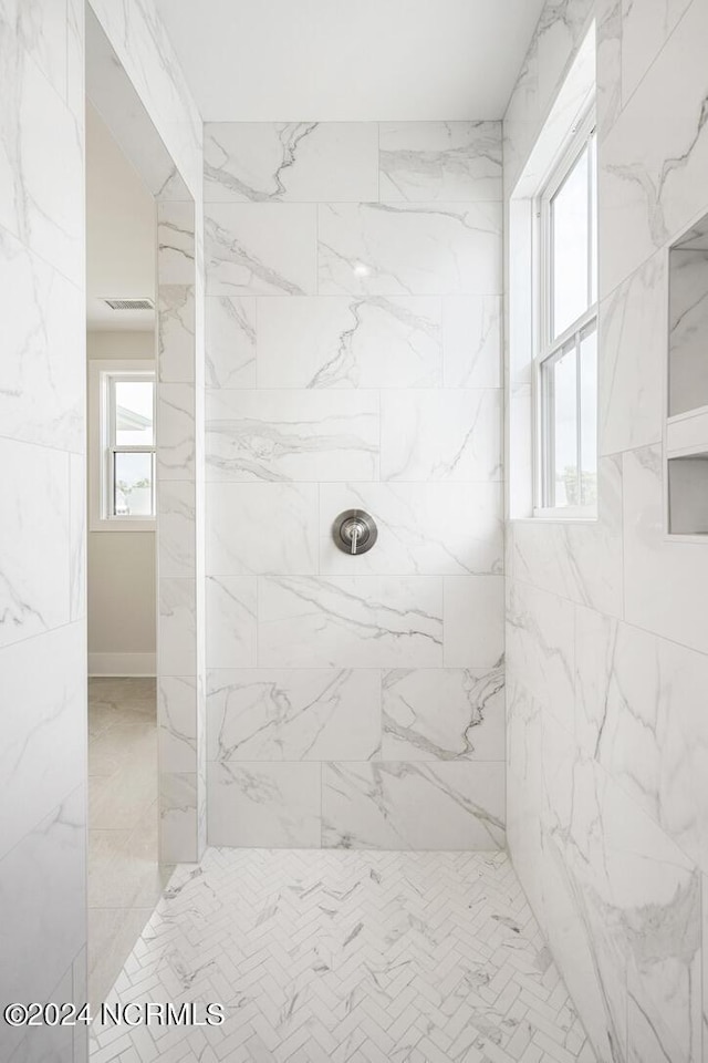 bathroom with tiled shower