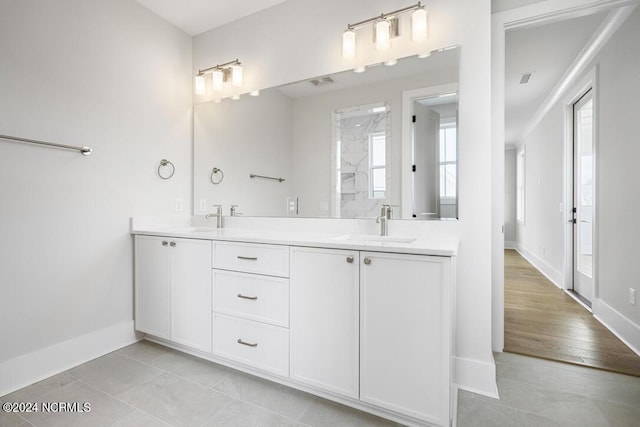 bathroom with vanity, walk in shower, and tile patterned floors