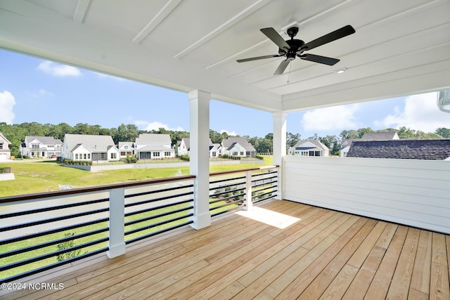 wooden deck with a lawn and ceiling fan