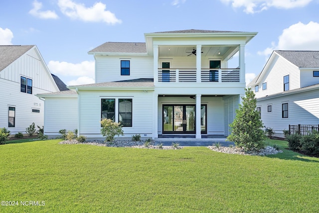 back of property featuring a balcony, a patio area, a yard, and ceiling fan