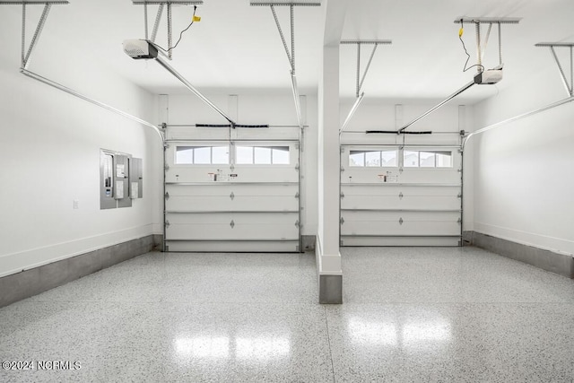 garage with electric panel and a garage door opener