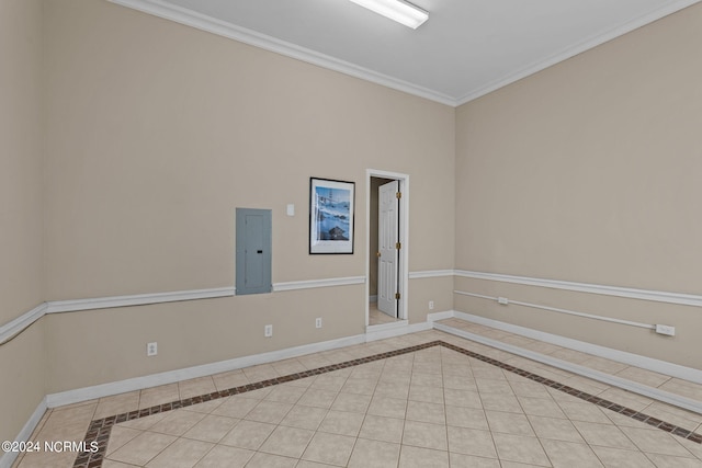 tiled spare room featuring electric panel and crown molding