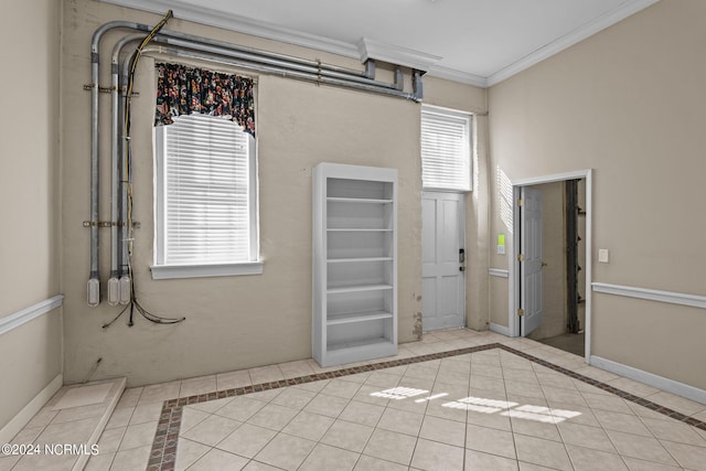 unfurnished room featuring light tile patterned floors and ornamental molding