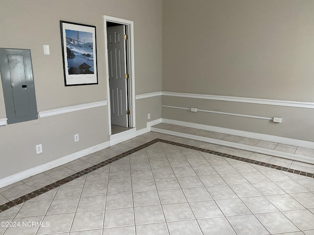 unfurnished room featuring light tile patterned floors and electric panel