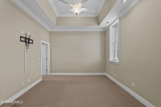 unfurnished room with carpet flooring, a tray ceiling, ceiling fan, and crown molding