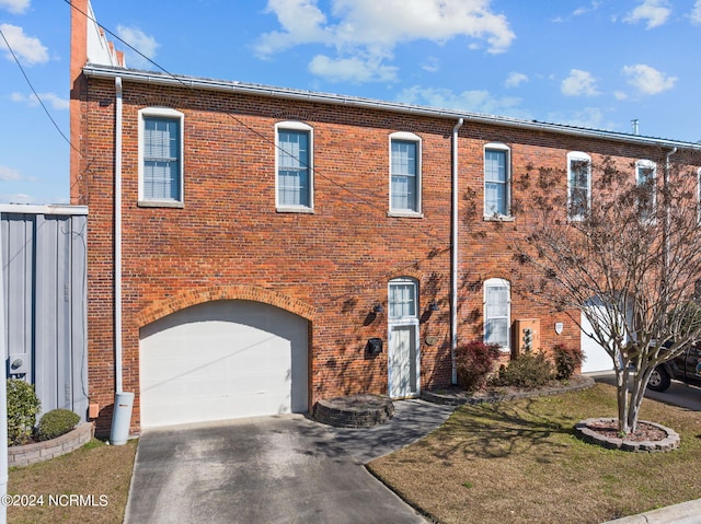 view of front of property with a garage and a front yard