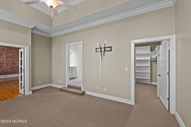 empty room with carpet, crown molding, and ceiling fan