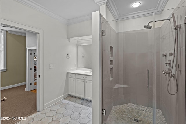 bathroom featuring vanity, crown molding, and a shower with shower door