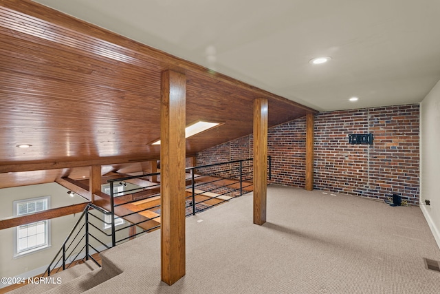 bonus room featuring light colored carpet, brick wall, and vaulted ceiling