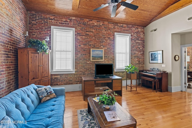 living room featuring light hardwood / wood-style floors, plenty of natural light, and brick wall