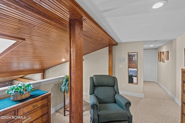 living area with light colored carpet and wood ceiling