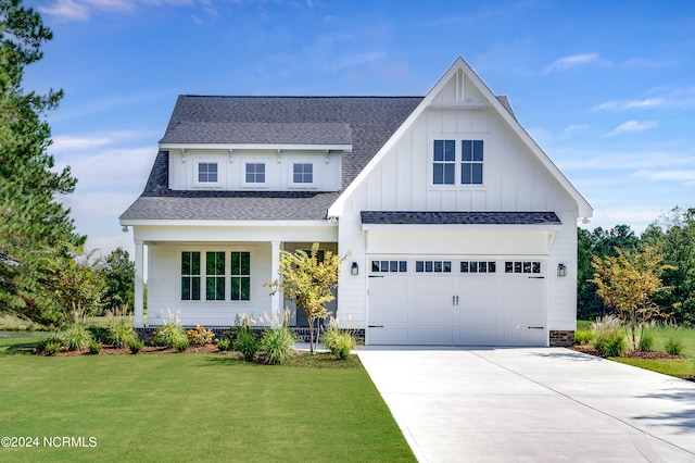 view of front of house with a garage and a front yard