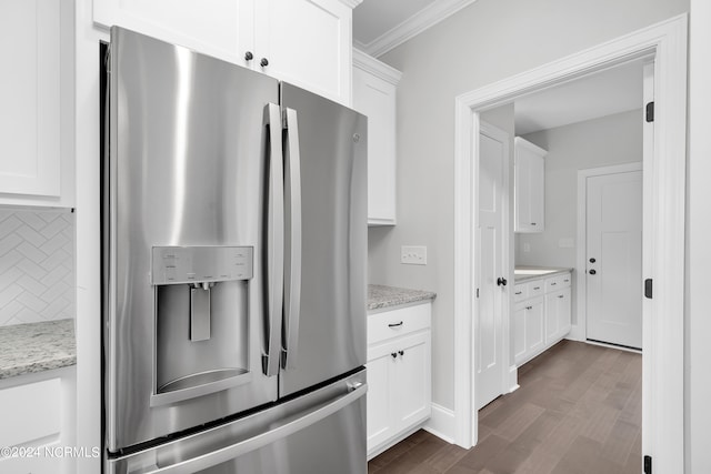 kitchen featuring white cabinets, light stone countertops, dark wood-type flooring, backsplash, and stainless steel fridge with ice dispenser