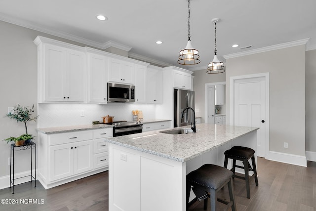 kitchen with decorative light fixtures, white cabinetry, stainless steel appliances, and dark hardwood / wood-style floors