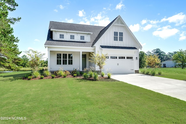 view of front of house with a front yard and a garage