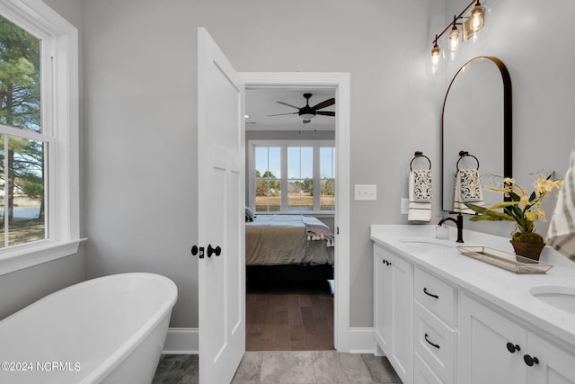 bathroom featuring tile flooring, a bathing tub, ceiling fan, and dual vanity