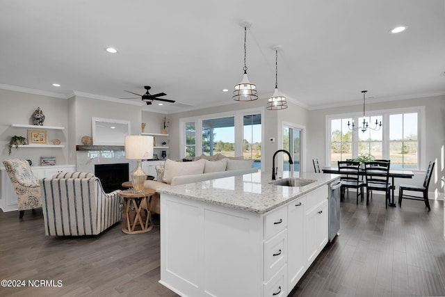 kitchen with white cabinets, sink, dishwasher, a center island with sink, and hardwood / wood-style flooring