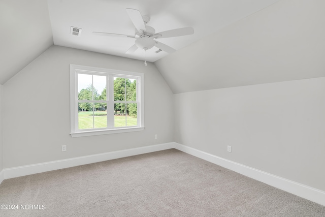 additional living space featuring light carpet, ceiling fan, and lofted ceiling