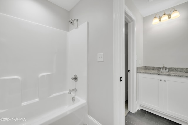 bathroom with vanity, bathing tub / shower combination, and tile floors