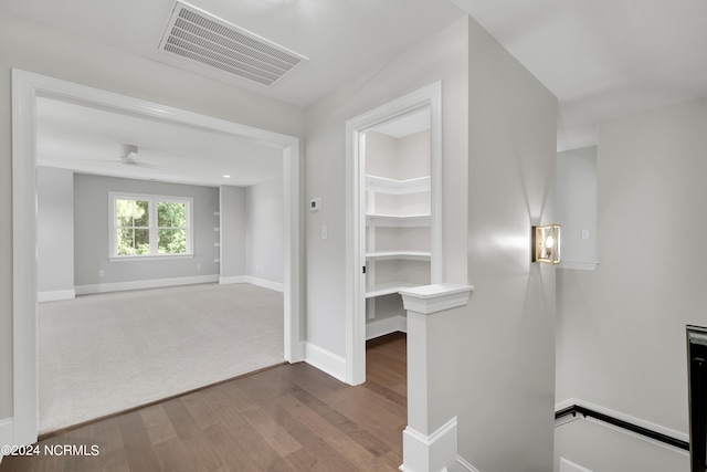 interior space featuring ceiling fan and dark colored carpet