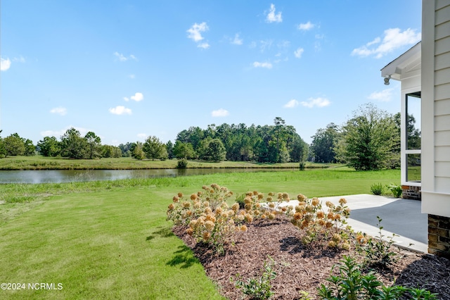 view of yard with a water view and a patio area