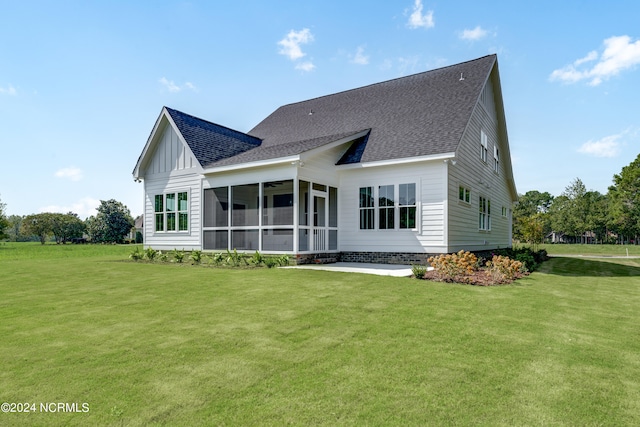 back of property with a yard and a sunroom