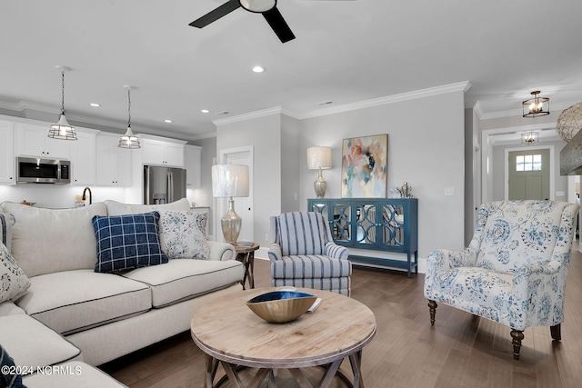 living room with ceiling fan, dark wood-type flooring, and ornamental molding