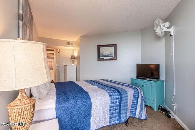 carpeted bedroom with a textured ceiling