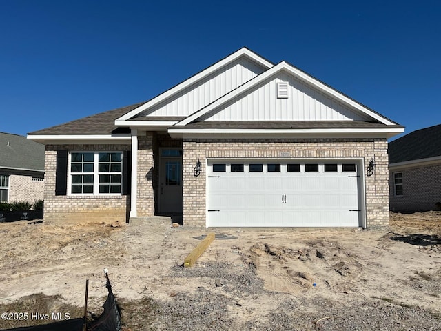 view of front of house featuring brick siding, board and batten siding, and an attached garage