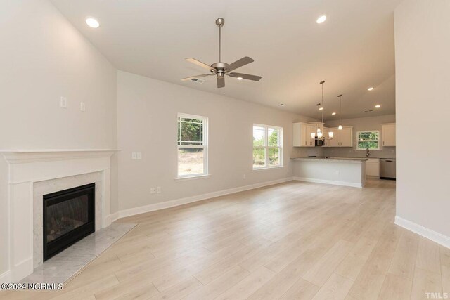 1204 Opaca Dr SE, Bolivia, NC 28422 - unfurnished living room with a ceiling fan, a premium fireplace, light wood-style floors, recessed lighting, and baseboards