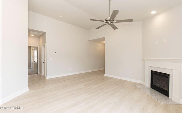 1204 Opaca Dr SE, Bolivia, NC 28422 - unfurnished living room featuring light wood-style flooring, a high end fireplace, ceiling fan, recessed lighting, and vaulted ceiling