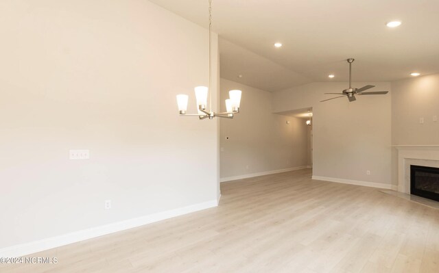 1204 Opaca Dr SE, Bolivia, NC 28422 - unfurnished living room with light wood-style floors, ceiling fan, a fireplace, baseboards, and lofted ceiling