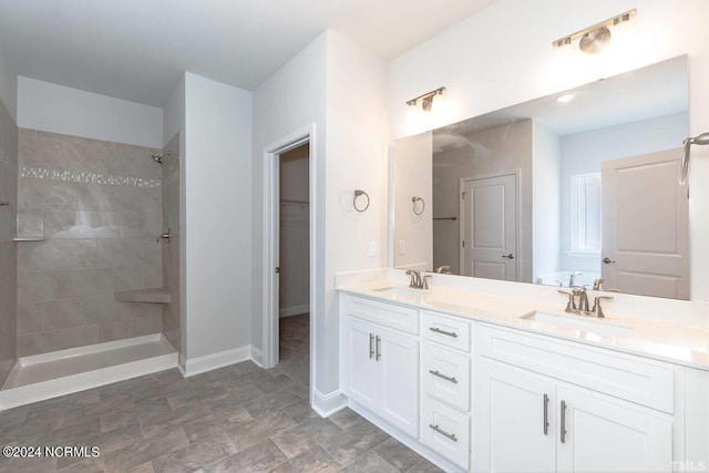 1204 Opaca Dr SE, Bolivia, NC 28422 - full bathroom featuring double vanity, tiled shower, baseboards, and a spacious closet