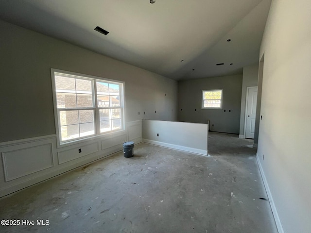 1204 Opaca Dr SE, Bolivia, NC 28422 - empty room with vaulted ceiling and concrete floors