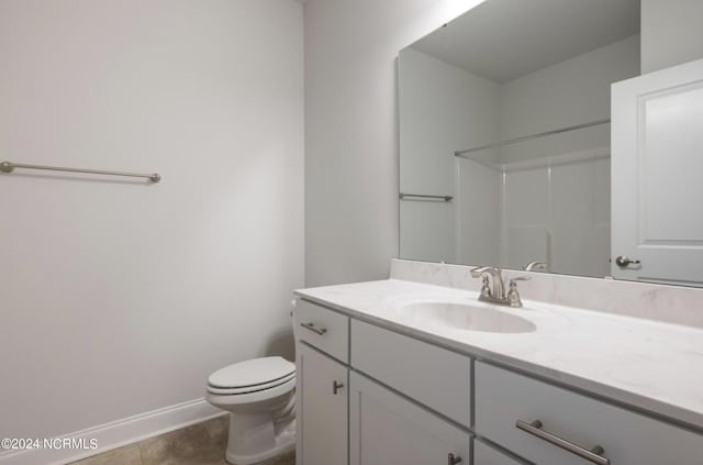 bathroom with baseboards, a shower, toilet, tile patterned flooring, and vanity