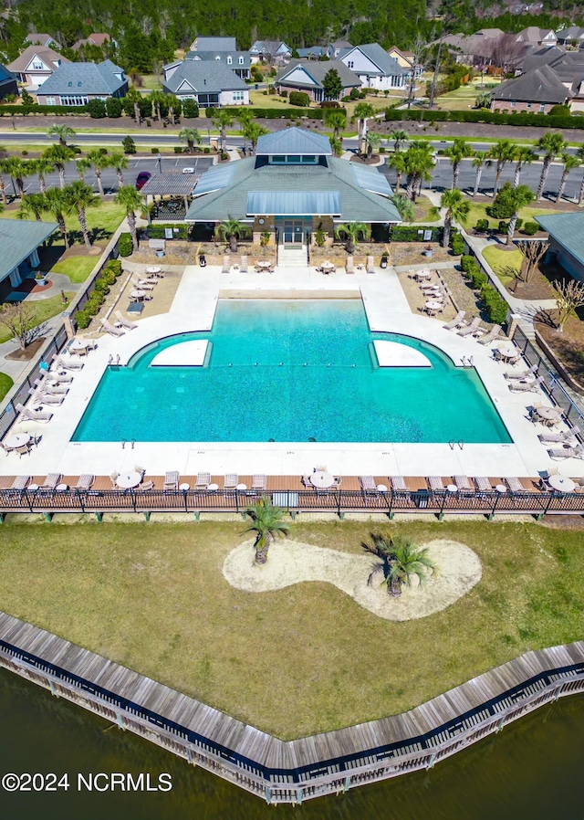 view of swimming pool featuring a patio and a residential view