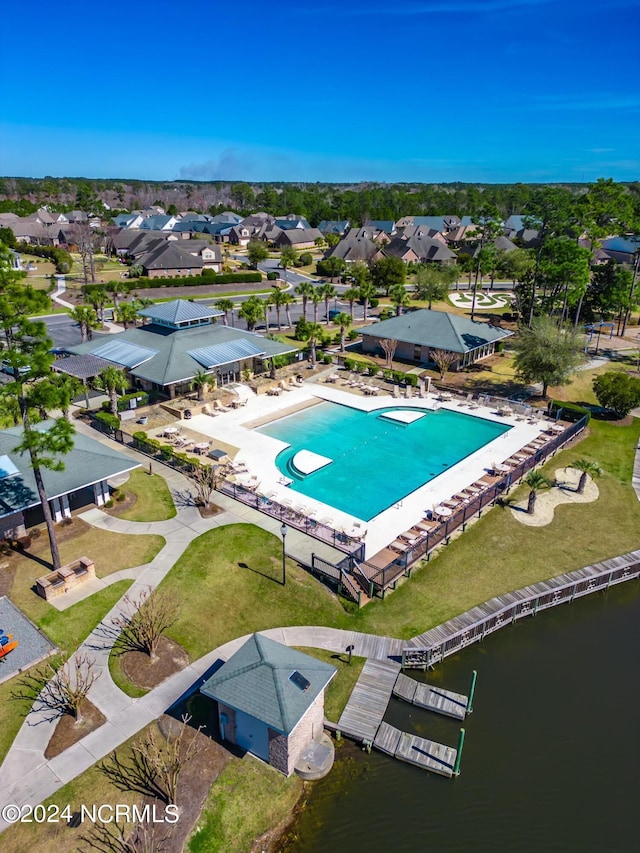 view of pool with a water view and a residential view