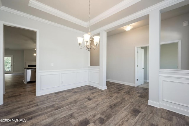 unfurnished dining area with dark wood-style floors, a wainscoted wall, ornamental molding, a tray ceiling, and a decorative wall