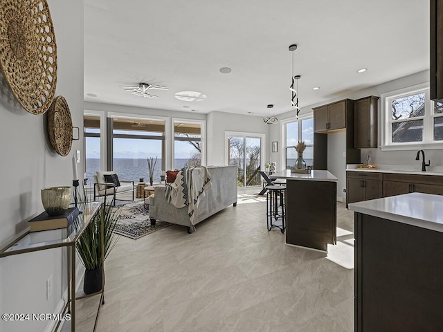 living room with a water view and recessed lighting