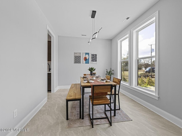 dining room featuring visible vents and baseboards