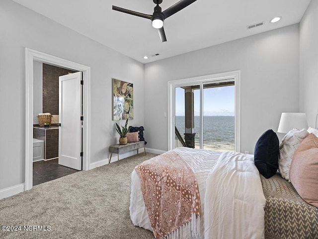 bedroom with a water view, visible vents, baseboards, access to outside, and dark colored carpet