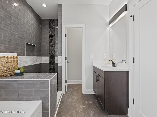 bathroom with baseboards, a tub, marble finish floor, vanity, and recessed lighting