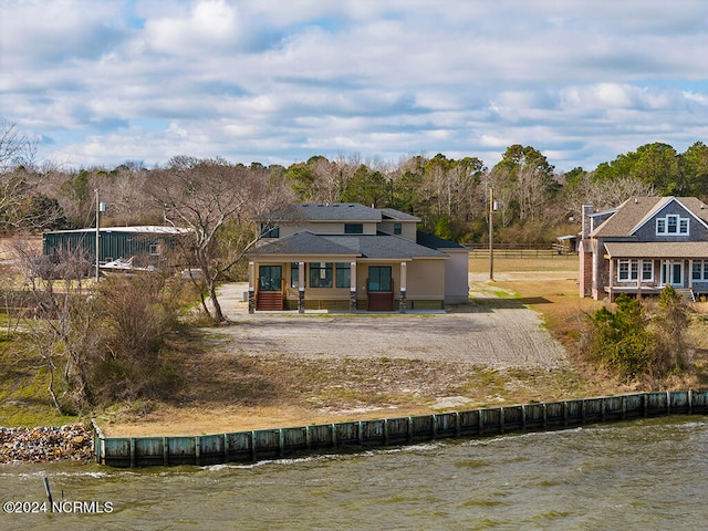 back of property with a water view