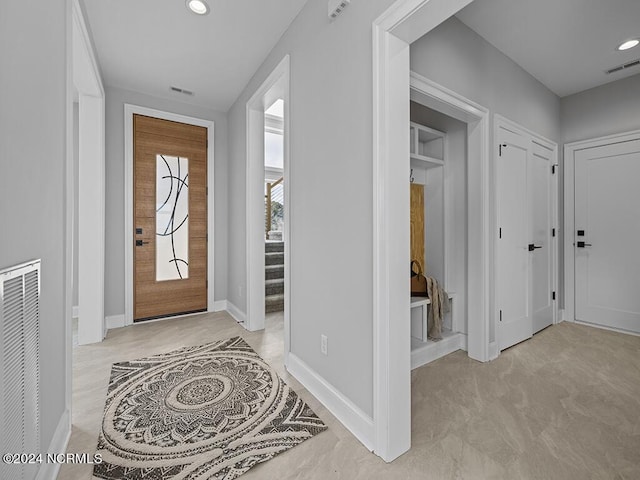 foyer featuring stairway, visible vents, and recessed lighting