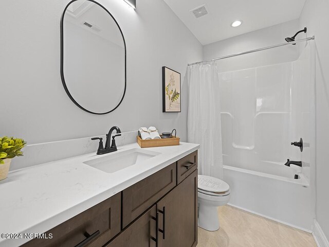 full bath with toilet, shower / bath combo with shower curtain, vanity, and visible vents