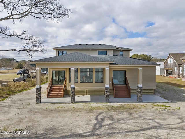 view of front of house with entry steps and a shingled roof