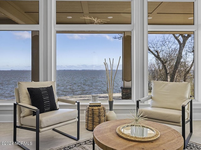 living area with a water view and wood finished floors