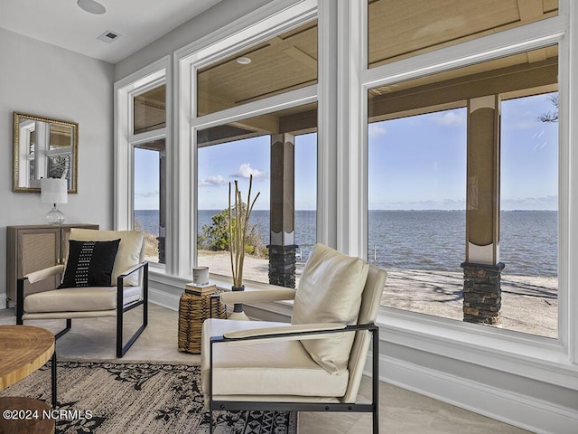 interior space featuring a water view, visible vents, and baseboards