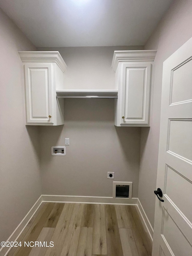 laundry area featuring cabinets, light hardwood / wood-style flooring, hookup for a washing machine, and electric dryer hookup