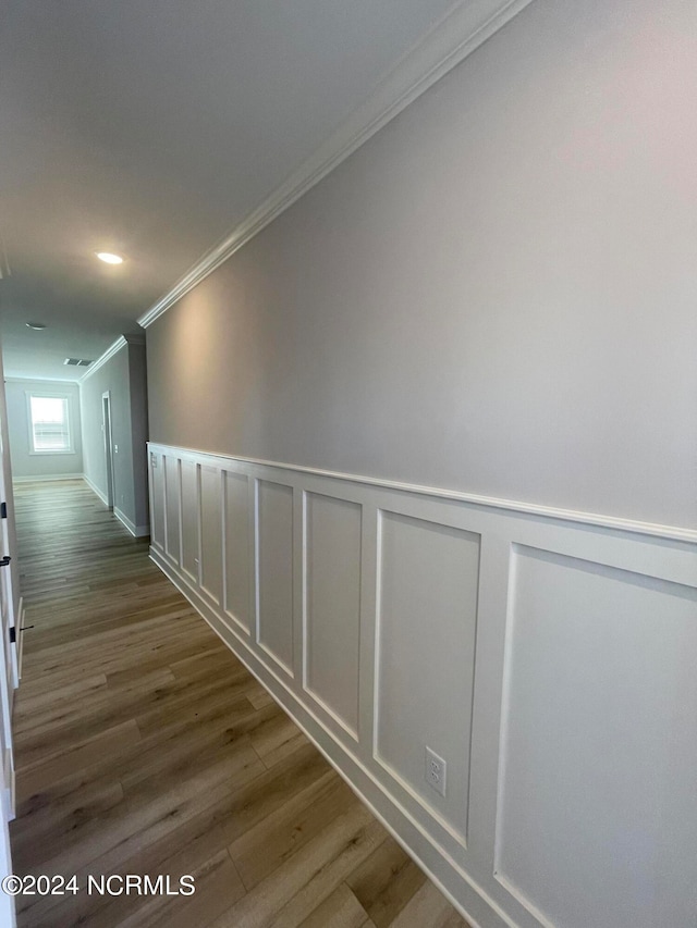 hall with ornamental molding and dark hardwood / wood-style floors